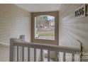 Hallway view looking through a window that overlooks the parking area and surrounding neighborhood at 1036 Plaza Walk Dr, Charlotte, NC 28215