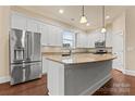 Modern kitchen features stainless steel appliances, granite countertops, and a large center island at 11604 Bradford Park Dr, Davidson, NC 28036