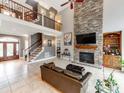 Open-concept living room with fireplace, stone accent wall, and access to the upper level at 123 Yellow Jacket Cir, Mooresville, NC 28117