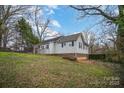 Exterior view of a well-maintained home featuring a fenced backyard and lush greenery at 1863 Hilltop Cir, Gastonia, NC 28054