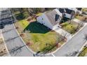 Aerial view of a single-Gathering home with a well-maintained lawn, mature trees, and a paved driveway at 201 Chestnut Ave, Tega Cay, SC 29708