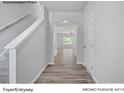 Bright entryway with wood flooring, an arched passageway, and a staircase at 213 Lake George Dr, Shelby, NC 28152