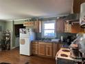 Charming kitchen with wood cabinets, a window, and appliances at 2318 W Main St, Albemarle, NC 28001