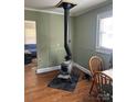 Cozy living room featuring a wood-burning stove and natural light at 2318 W Main St, Albemarle, NC 28001