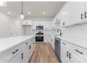 Bright kitchen features white cabinets, stainless steel appliances, subway tile backsplash, and a large kitchen island at 2825 New Pineola Rd # 7A, Charlotte, NC 28208