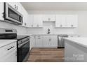 Modern kitchen featuring stainless steel appliances, white cabinetry, matte black hardware, and subway tile backsplash at 2825 New Pineola Rd # 7A, Charlotte, NC 28208