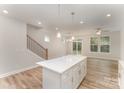 Kitchen island with white countertop and cabinets, open floorplan with living and dining area at 2825 New Pineola Rd # 7A, Charlotte, NC 28208