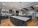 Open-concept kitchen and living room featuring a large island, modern lighting, and a cozy fireplace at 329 Wintergreen Ct, Kings Mountain, NC 28086