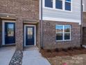 Inviting townhome exterior with brick facade, private entryways, and well-maintained landscaping at 3928 Craig Ave, Charlotte, NC 28211