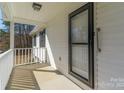 Cozy covered front porch with secure black-framed glass door and white railings at 4175 Barnell Ln, Maiden, NC 28650