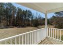 Serene view from the covered porch overlooking the expansive front yard and surrounding greenery at 4175 Barnell Ln, Maiden, NC 28650