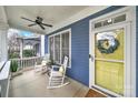 Inviting front porch with rocking chairs, a ceiling fan, and a sunny yellow front door at 431 Third Baxter St, Fort Mill, SC 29708