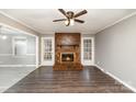 Welcoming living room with cozy brick fireplace and wood flooring at 4815 Carriage Drive Cir, Charlotte, NC 28205