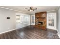Inviting living room with a red brick fireplace and dark hardwood floors at 4815 Carriage Drive Cir, Charlotte, NC 28205