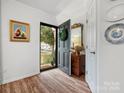 Open entryway with hardwood floors and decorative mirror and table at 613 Lynn St, Waxhaw, NC 28173