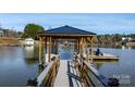 Private boat dock with covered area, providing easy access to the lake for boating and recreation at 6233 Riviera Run Estates Dr, Hickory, NC 28601
