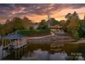 Beautiful waterfront home with a private dock, lush landscaping, and stunning sunset views at 6233 Riviera Run Estates Dr, Hickory, NC 28601