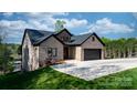 Charming brick home with a spacious driveway and well-manicured lawn, perfect for curb appeal at 6233 Riviera Run Estates Dr, Hickory, NC 28601