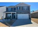 Beautiful two-story home with stone accents, a two-car garage, and a well-maintained lawn at 7711 Bainbridge Rd, Sherrills Ford, NC 28673