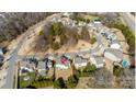 Aerial view of a neighborhood with tree-lined streets, well-maintained houses and a manicured lawn at 9012 Krestridge View Dr, Huntersville, NC 28078