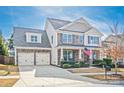Charming two-story home with stone and siding, a well-manicured lawn, and a two-car garage at 9012 Krestridge View Dr, Huntersville, NC 28078