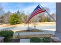 Well-maintained front yard with green bushes and landscaped beds, viewed from a covered front porch at 9012 Krestridge View Dr, Huntersville, NC 28078