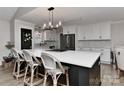 Modern kitchen boasts a large island with bar seating and stainless steel appliances, perfect for entertaining at 9414 Machado Dr, Indian Trail, NC 28079
