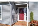 Inviting front entry featuring brick step, burgundy door, lantern, and low maintenance shrubbery at 1027 21St Ne Ave, Hickory, NC 28601