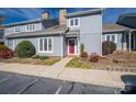 Attractive townhome featuring red front door, tidy landscaping, gray siding and a welcoming entryway at 1027 21St Ne Ave, Hickory, NC 28601