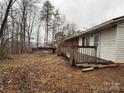 View of the backyard showcasing a small wooden shed and wooded landscape at 1031 Cheatham Ford Rd Cheatham Ford Rd, Hiddenite, NC 28636
