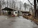 Exterior of a ranch home with a large covered carport and paved driveway at 1031 Cheatham Ford Rd Cheatham Ford Rd, Hiddenite, NC 28636