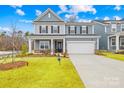 Charming two-story home with a covered porch and attached two car garage at 118 Golden Trl, Mooresville, NC 28115