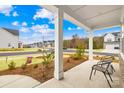 Inviting covered porch with ample seating and views of the landscaped front yard at 118 Golden Trl, Mooresville, NC 28115
