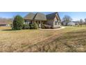 Traditional home featuring a well-manicured lawn, inviting walkway, and classic design at 125 Round Tuit Ln, Mt Ulla, NC 28125