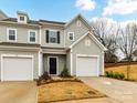 Charming townhome with light gray siding, black shutters, and an attached one-car garage at 1365 Eagle Claw Dr, Kannapolis, NC 28083
