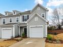 Charming townhome with light gray siding, black shutters, and an attached one-car garage at 1365 Eagle Claw Dr, Kannapolis, NC 28083