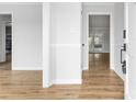 Bright entryway featuring wood-look flooring and white trim, leading to other rooms in the home at 137 Dellinger Dr, Statesville, NC 28625