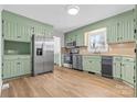 Spacious kitchen with stainless steel appliances and green cabinets, offering ample counter space at 137 Dellinger Dr, Statesville, NC 28625