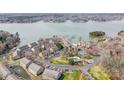 Aerial view of waterfront condos, showcasing lush landscaping and the community's prime location on the lake at 14021 Queens Harbor Rd, Charlotte, NC 28278