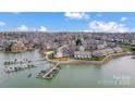 Stunning aerial shot of waterfront condos with a boat dock offering picturesque views and convenient access to the water at 14021 Queens Harbor Rd, Charlotte, NC 28278