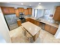 Open kitchen with stainless steel appliances, tile backsplash, island, and ample cabinet space at 2023 Moultrie Ct, Fort Mill, SC 29707