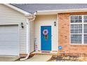 Close-up of the entryway, featuring a blue front door with a decorative wreath and a 'Welcome' sign at 2232 Mancke Dr, Rock Hill, SC 29732