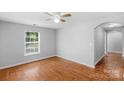 Neutral bedroom showcasing wood-look flooring, a ceiling fan, and a sunlit window at 233 Proctor St, Gastonia, NC 28052