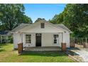 Charming single-story home featuring a welcoming front porch, neat lawn, and quaint front door at 233 Proctor St, Gastonia, NC 28052