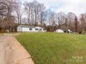 Expansive yard showcasing the home's exterior with additional buildings at 236 Sailwinds Rd, Mooresville, NC 28115