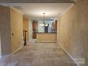 Spacious living area with tiled flooring, connecting seamlessly to the kitchen, perfect for open-concept living at 2656 Polo Club Blvd, Matthews, NC 28105