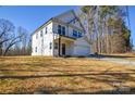 Charming two-story house featuring white siding, large windows, and a well-maintained lawn at 268 Lytton Farm Rd, Troutman, NC 28166