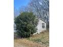 Single-story home with white siding and dark shutters surrounded by trees at 282 Dixon Rd, Lancaster, SC 29720