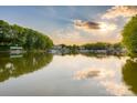 Scenic lake view featuring the calm water with boat docks surrounded by trees and various homes at 324 Bridgewater Ln, Mooresville, NC 28117