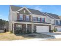 Inviting two-story home with brick accents, a two-car garage, and well-maintained landscaping at 4253 Spadefoot Ct, Lancaster, SC 29720
